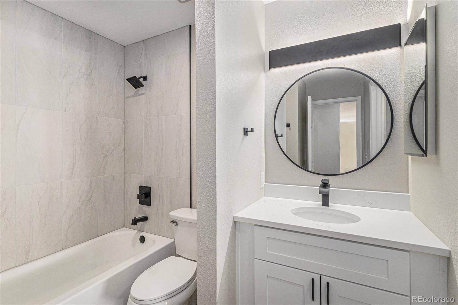 8414 South Everett Way, Unit F Littleton, CO 80128 - Photo 8 of 13 a bathroom with a sink toilet and shower