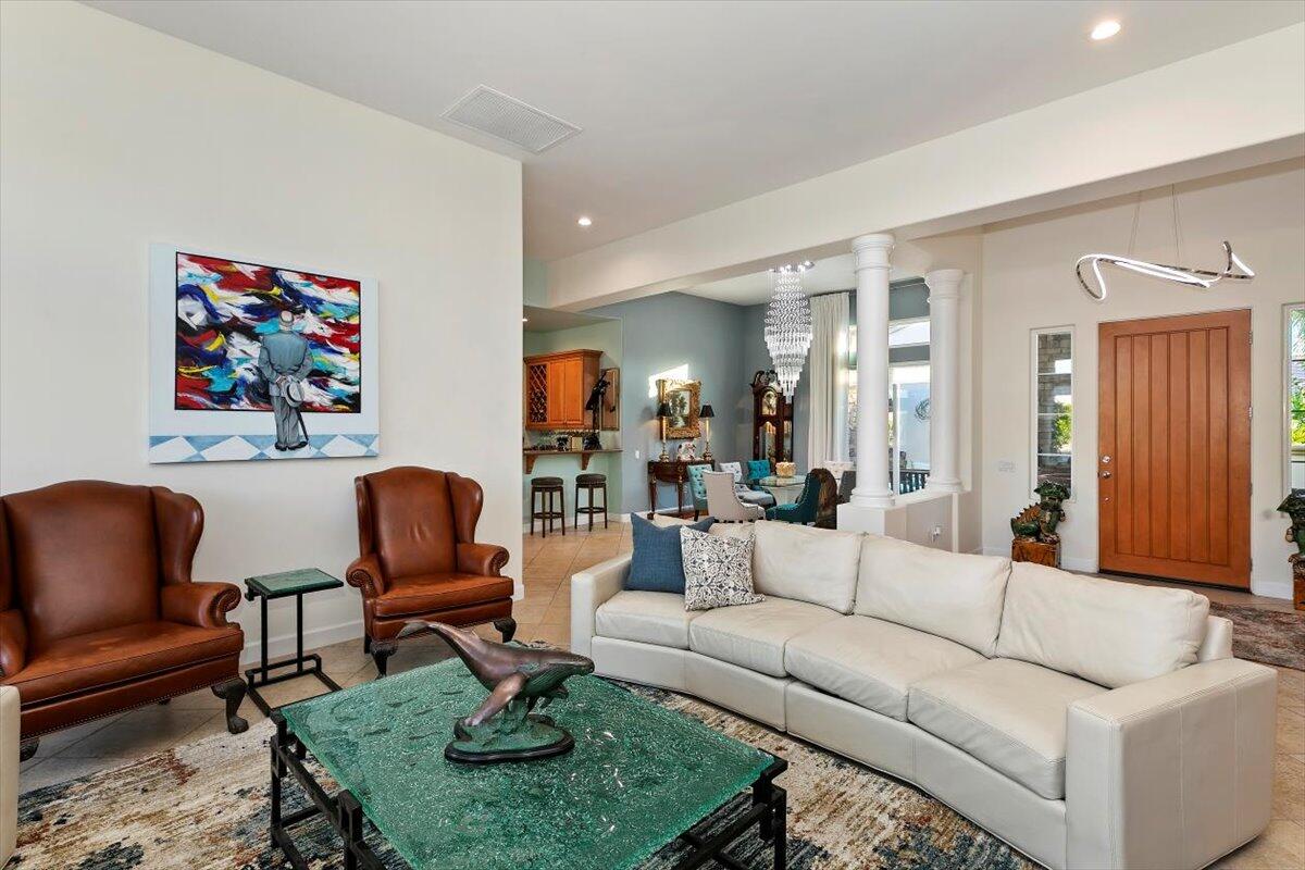 50 Toscana Way East Rancho Mirage, CA 92270 - Photo 23 of 87 a living room with furniture a rug and a painting