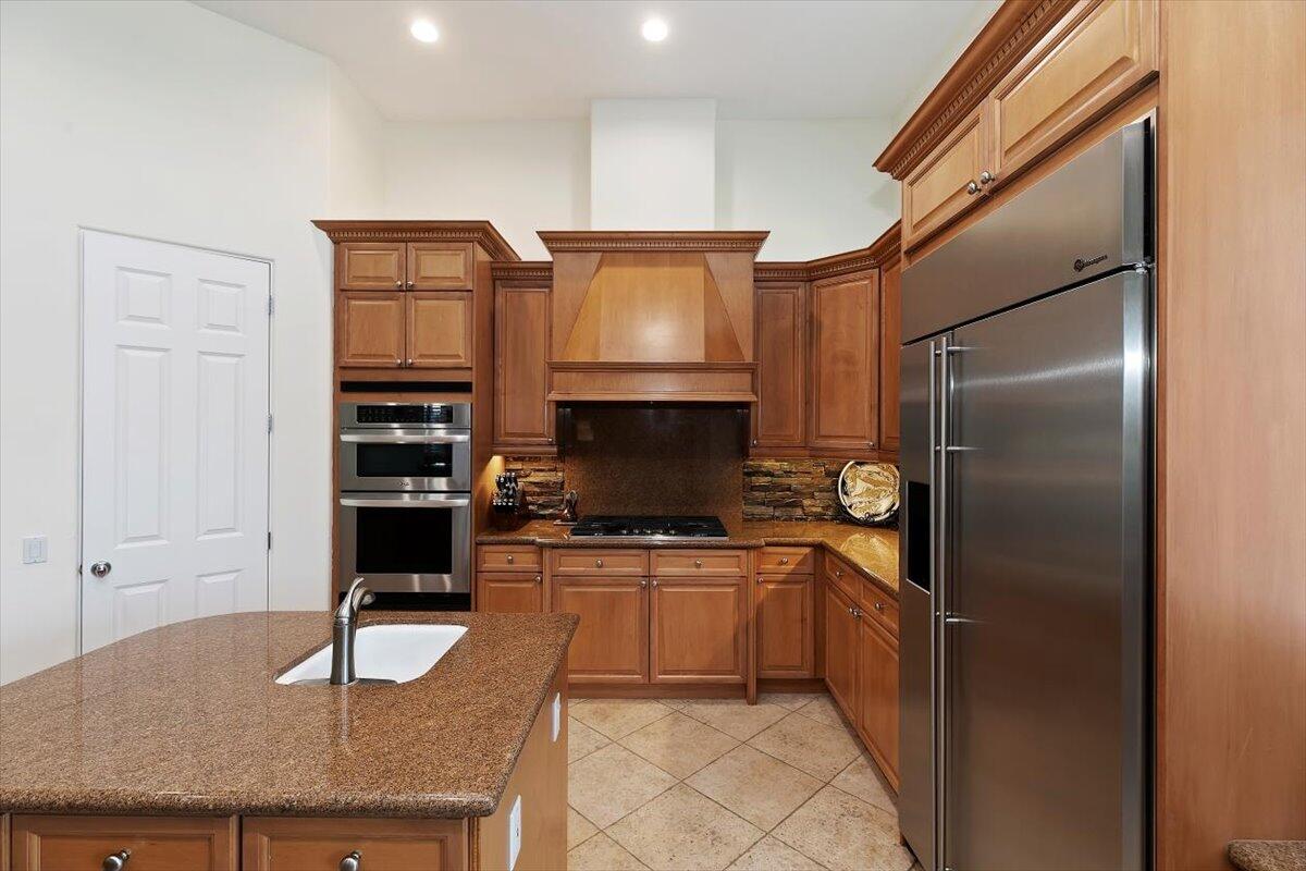 50 Toscana Way East Rancho Mirage, CA 92270 - Photo 33 of 87 a kitchen with stainless steel appliances granite countertop a sink stove and refrigerator