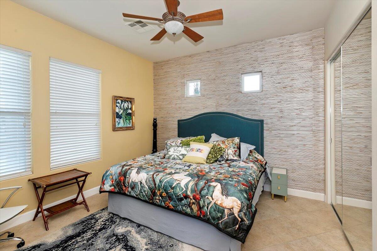 50 Toscana Way East Rancho Mirage, CA 92270 - Photo 60 of 87 a bedroom with a bed chair and a window