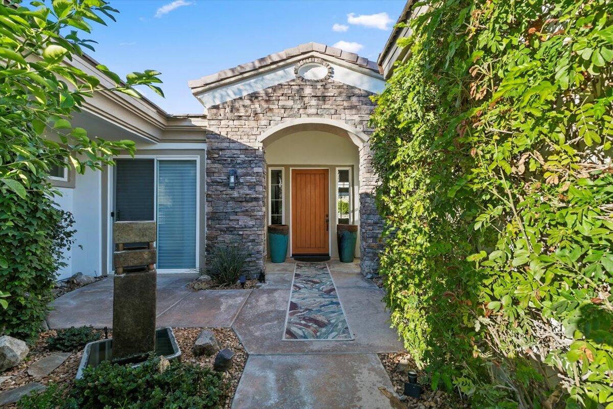 50 Toscana Way East Rancho Mirage, CA 92270 - Photo 71 of 87 a view of a brick house with plants and large tree