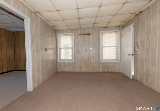 a bathroom with a toilet a sink a mirror and a bathtub