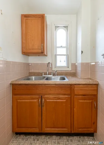 a kitchen with granite countertop cabinets sink and window