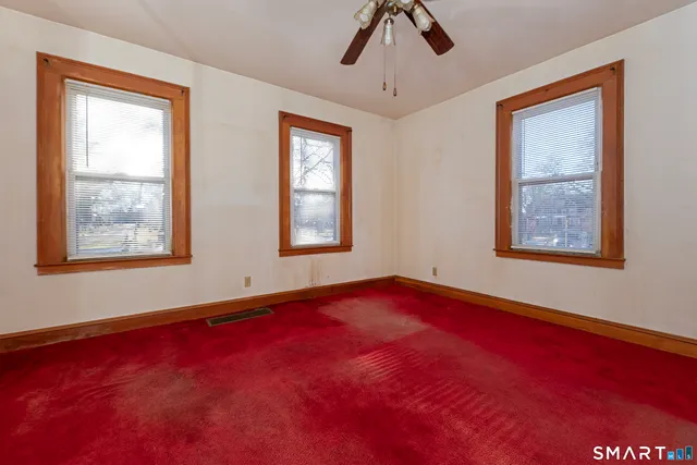 a view of an empty room with windows