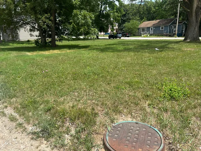 a backyard of a house with lots of green space and stainless steel appliances