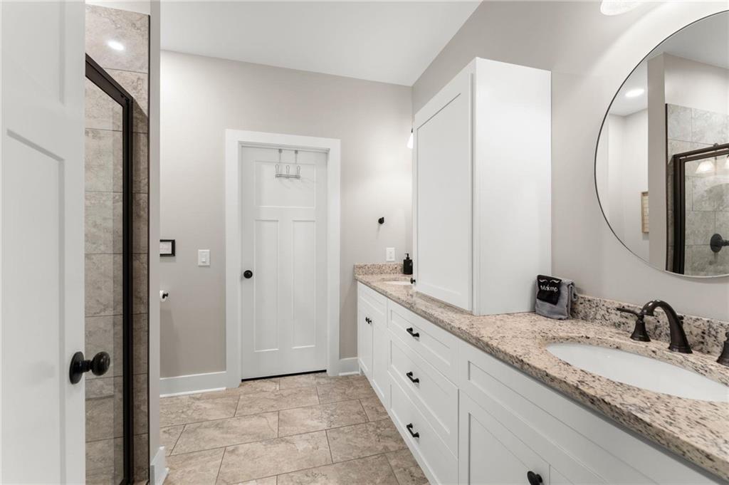 1320 Preacher Campbell Road Clarkesville, GA 30523 - Photo 14 of 36 a bathroom with a granite countertop double vanity sink and mirror
