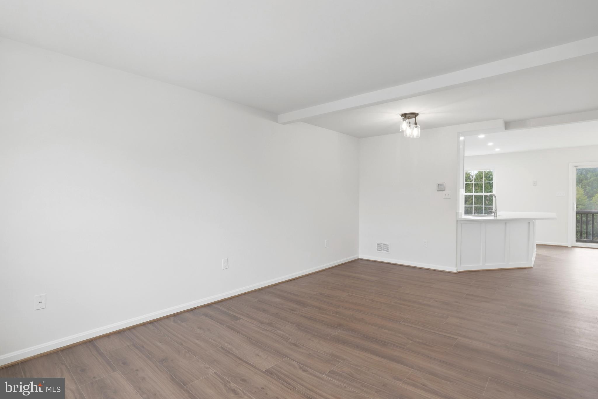 14275 Newbern Loop Gainesville, VA 20155 - Photo 12 of 35 a view of an empty room with wooden floor and a window