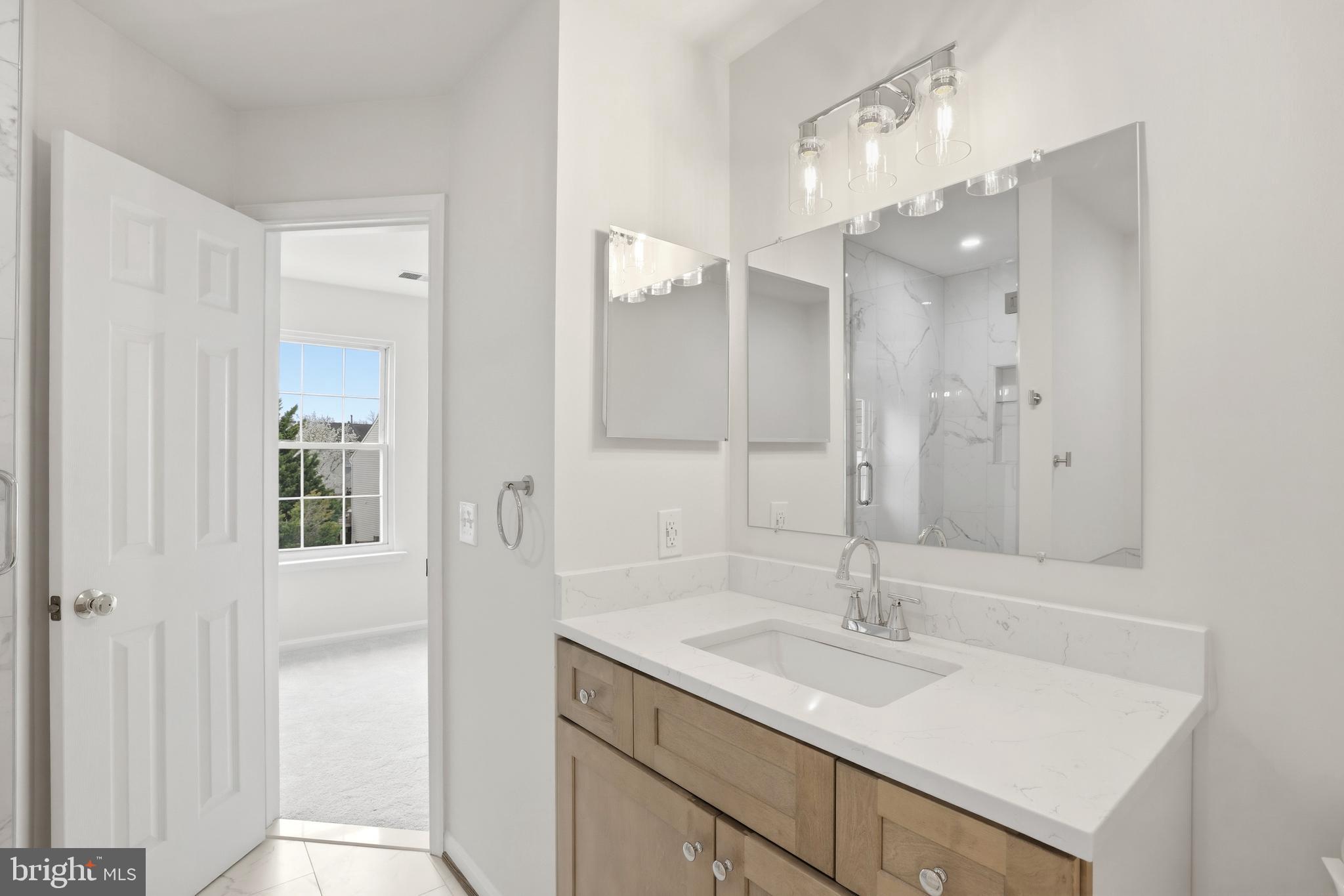 14275 Newbern Loop Gainesville, VA 20155 - Photo 18 of 35 a bathroom with a sink double vanity and a mirror