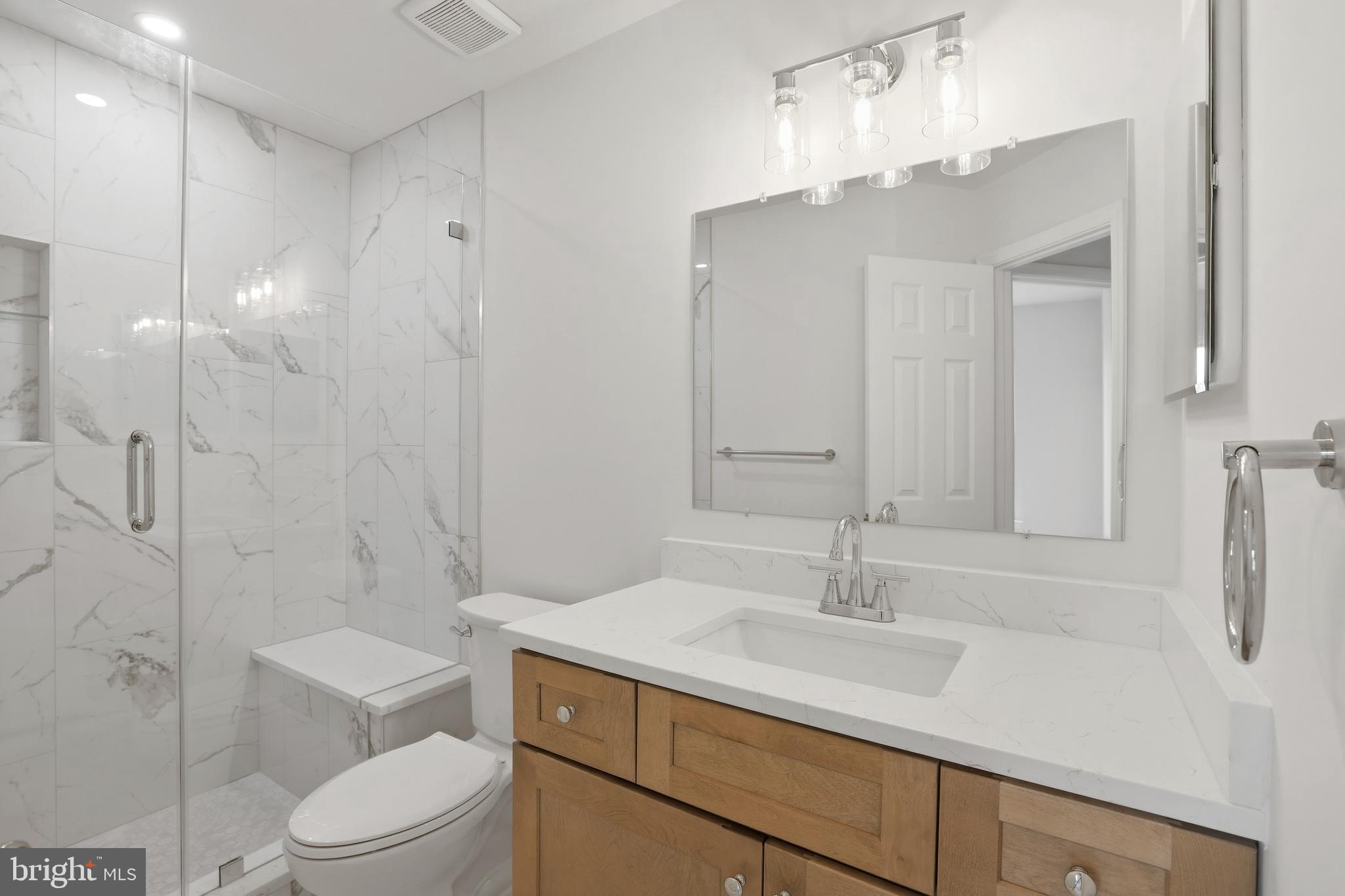 14275 Newbern Loop Gainesville, VA 20155 - Photo 21 of 35 a bathroom with a sink a toilet and shower