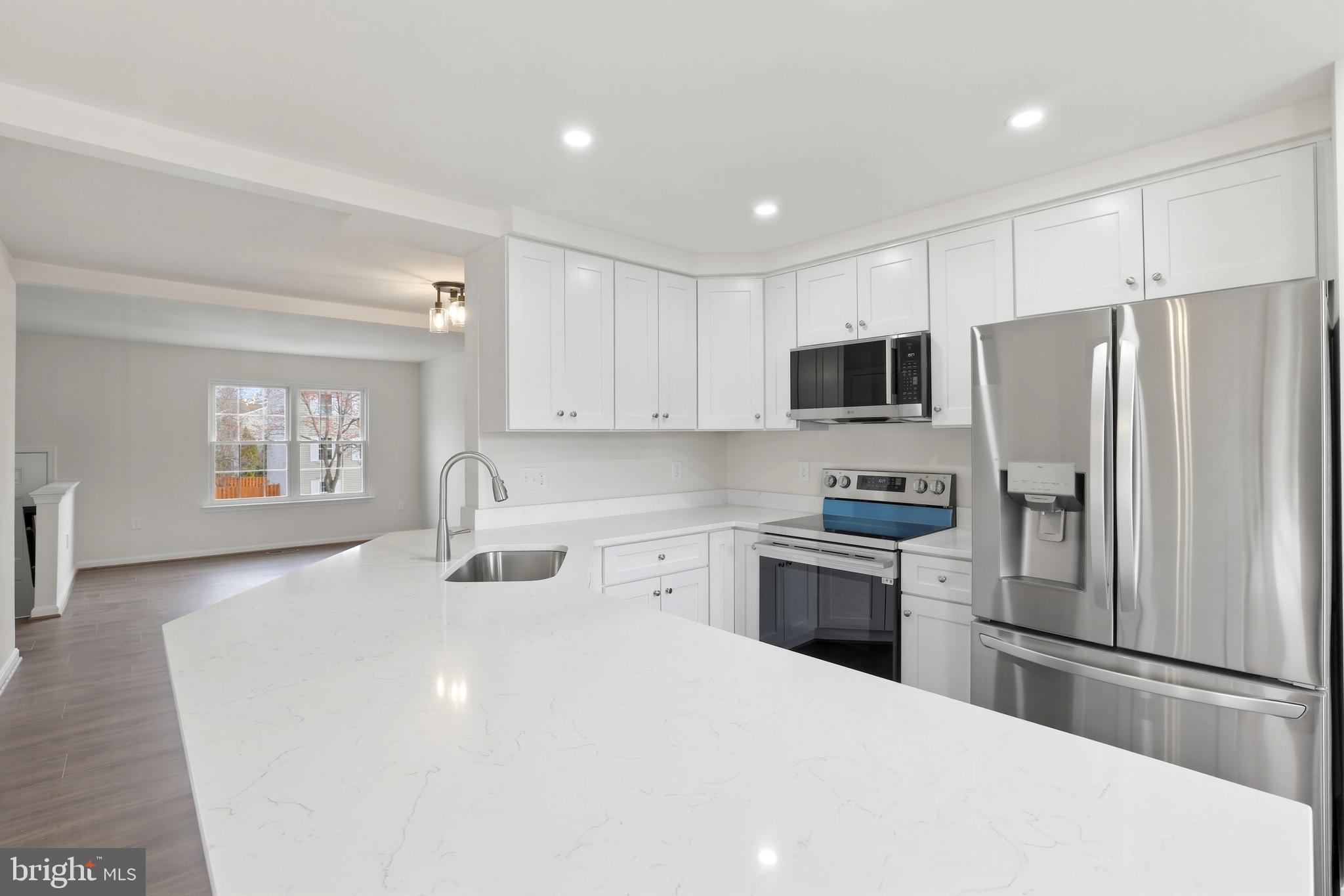 14275 Newbern Loop Gainesville, VA 20155 - Photo 3 of 35 a kitchen with a refrigerator a stove top oven a sink and dishwasher