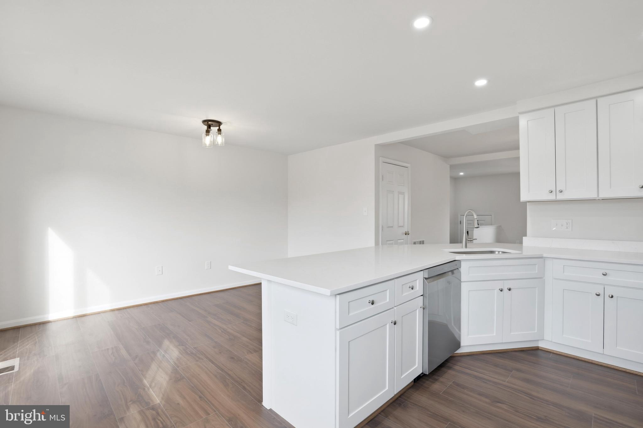 14275 Newbern Loop Gainesville, VA 20155 - Photo 4 of 35 a kitchen with a sink cabinets and wooden floor