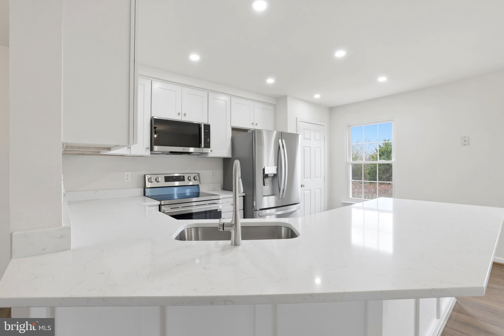 14275 Newbern Loop Gainesville, VA 20155 - Photo 6 of 35 a kitchen with stainless steel appliances granite countertop a refrigerator and a sink