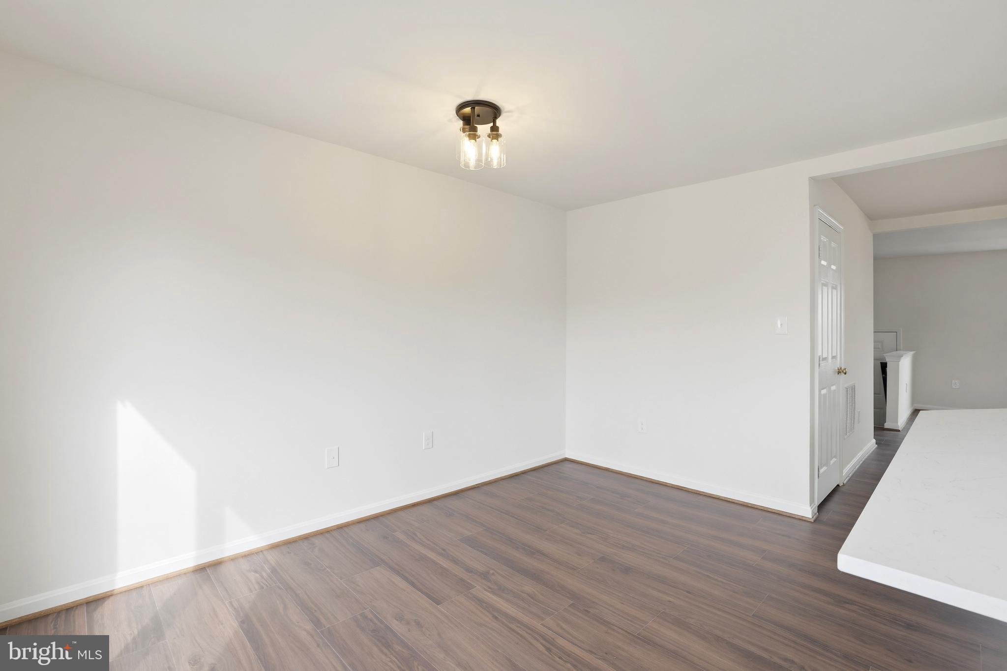 14275 Newbern Loop Gainesville, VA 20155 - Photo 7 of 35 a view of a room with wooden floor and white walls