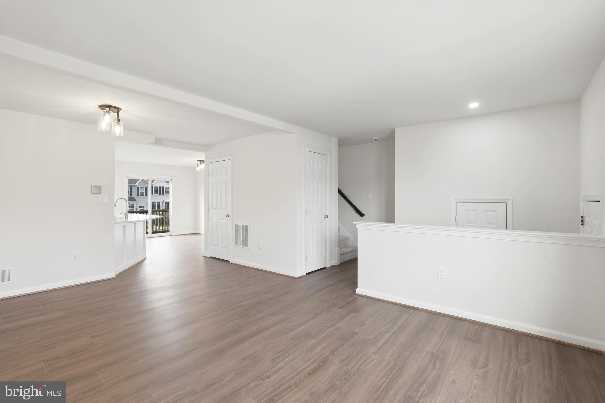 14275 Newbern Loop Gainesville, VA 20155 - Photo 9 of 35 a view of an empty room with wooden floor and a window