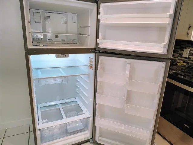 a kitchen with a refrigerator and a sink