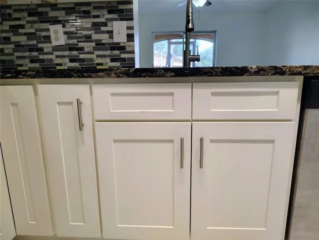 a kitchen with a sink and a wooden floor