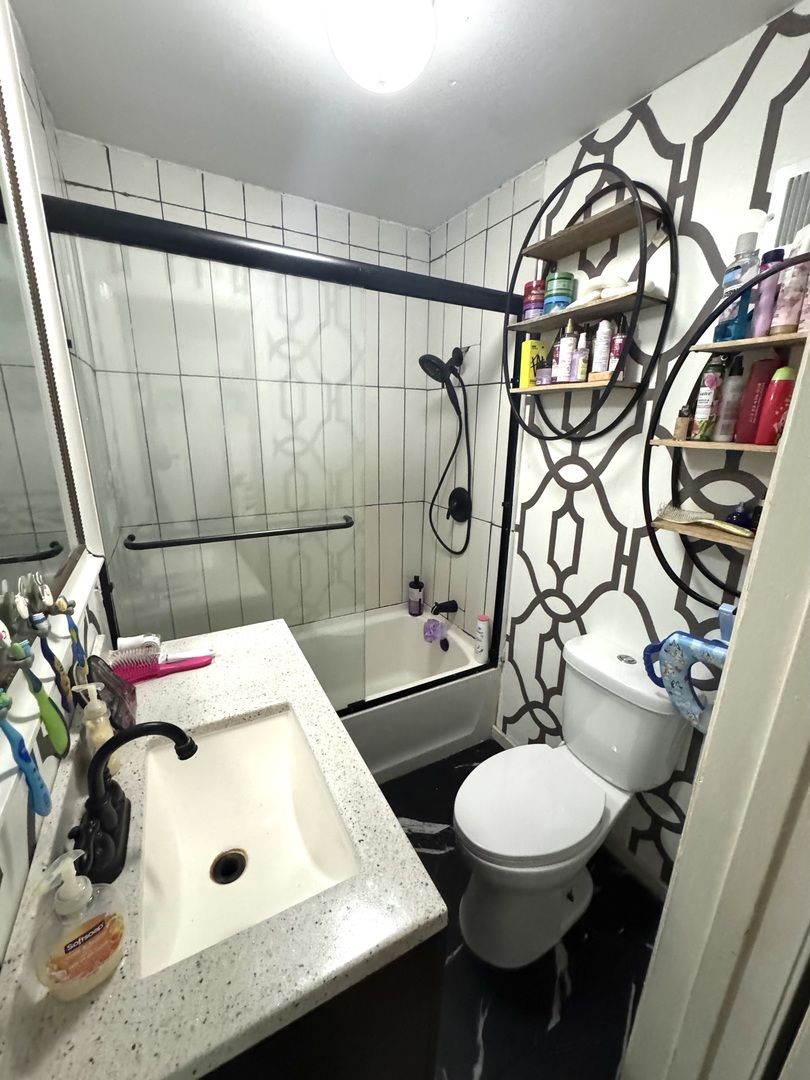 931 South Rawson Bridge Road Cary, IL 60013 - Photo 32 of 36 a bathroom with a sink a toilet and shower curtain