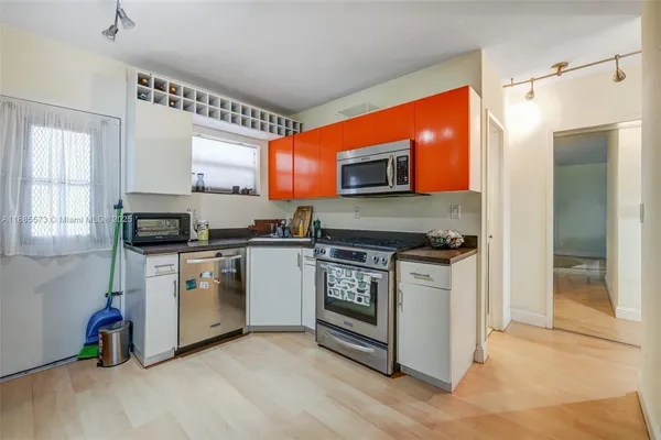 a kitchen with stainless steel appliances a stove a sink and a refrigerator