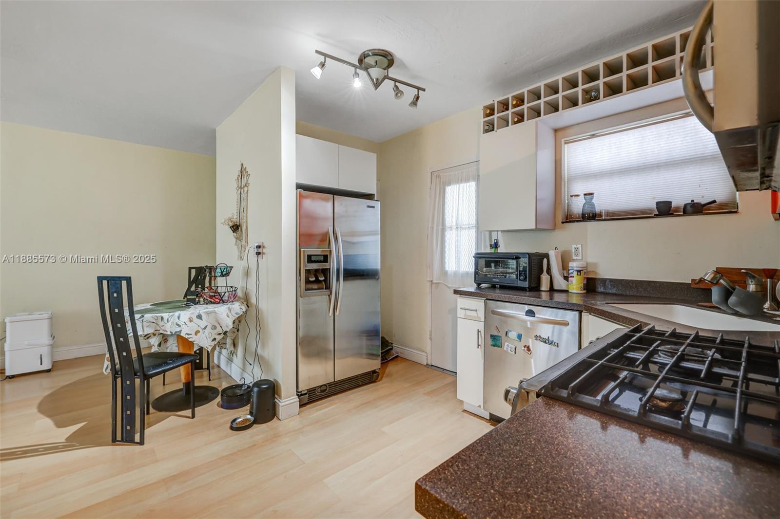 1300 Lincoln Road, Unit B402 Miami Beach, FL 33139 - Photo 14 of 34 a kitchen with stainless steel appliances a stove a sink and a refrigerator