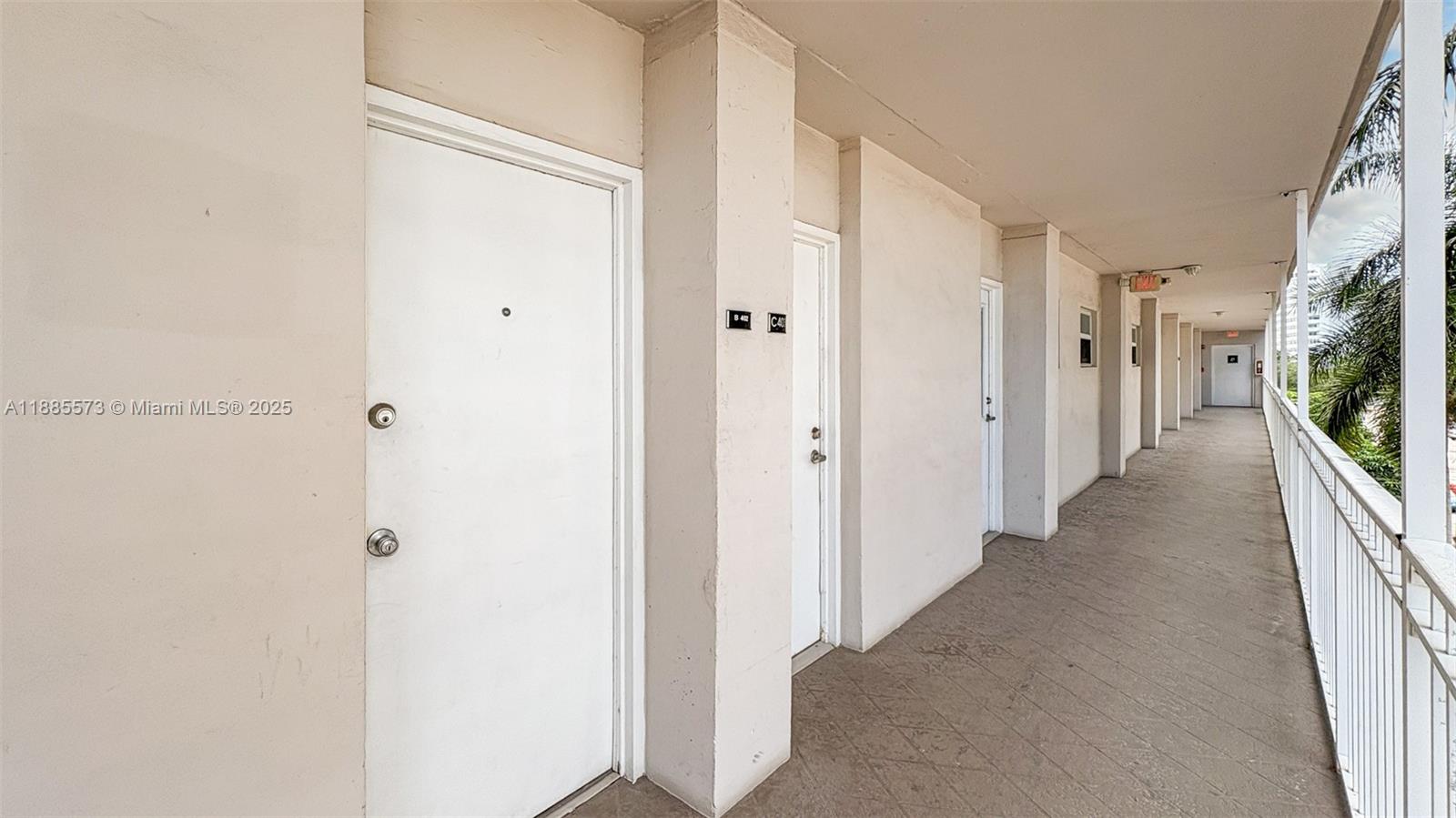 1300 Lincoln Road, Unit B402 Miami Beach, FL 33139 - Photo 24 of 34 a view of a hallway with wooden floor and a bathroom
