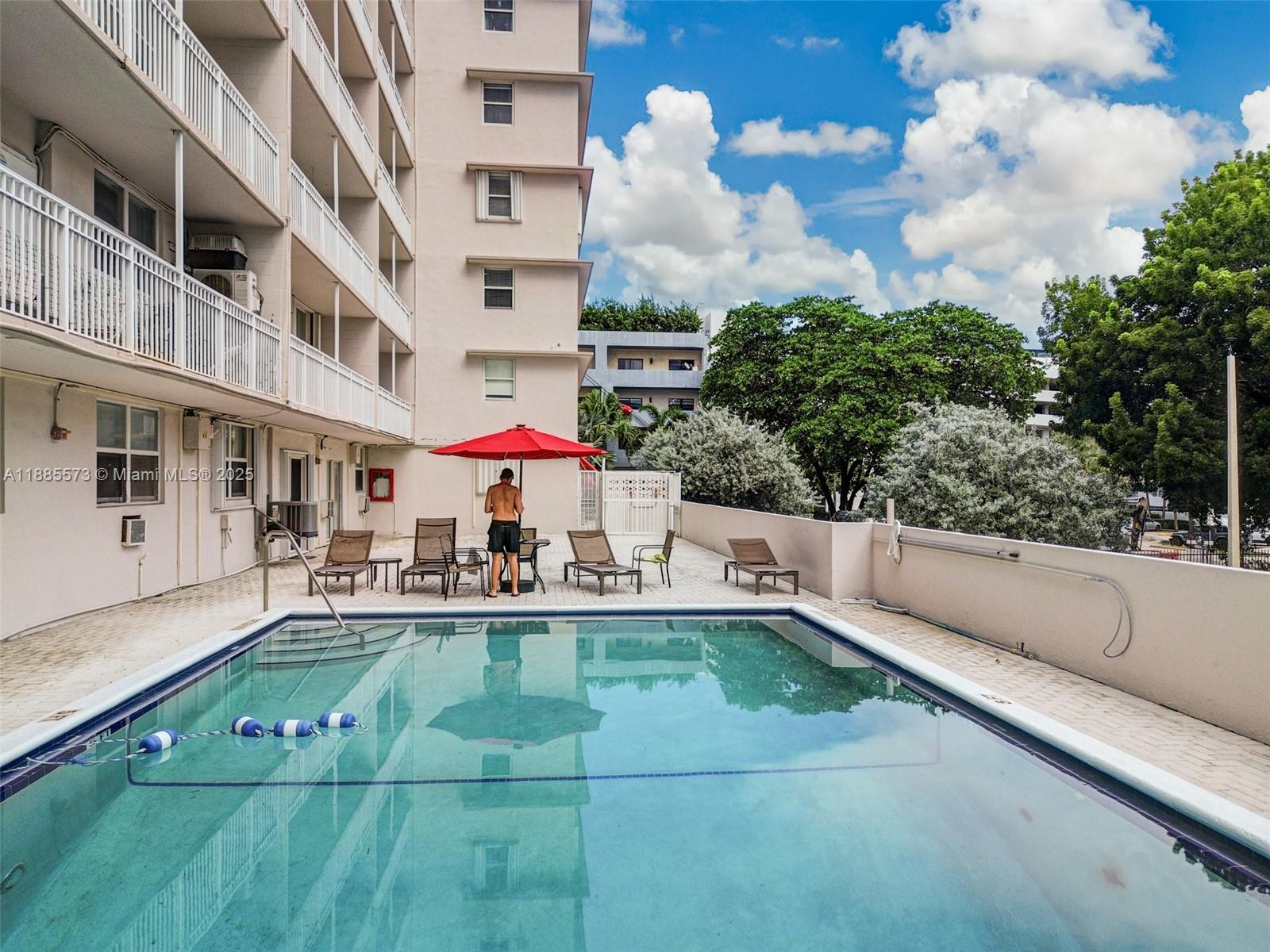 1300 Lincoln Road, Unit B402 Miami Beach, FL 33139 - Photo 28 of 34 a view of a patio with dining table and chairs with plants