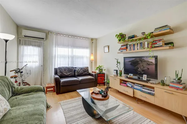 a living room with furniture potted plant and a fireplace