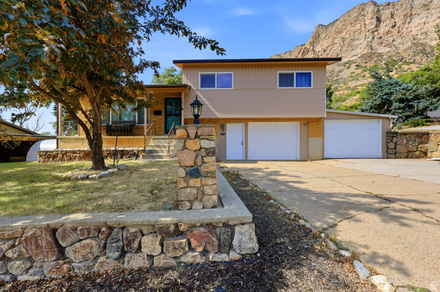 1486 3rd Street Ogden, UT 84404 - Photo 1 of 26 Split-level residence featuring a tan exterior and a prominent mountain backdrop