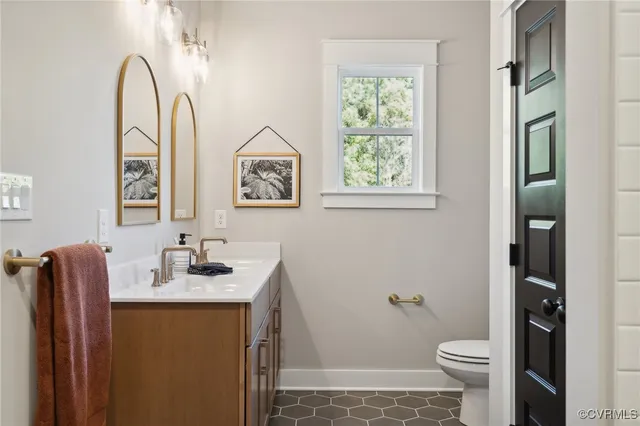 a bathroom with a sink toilet and a mirror