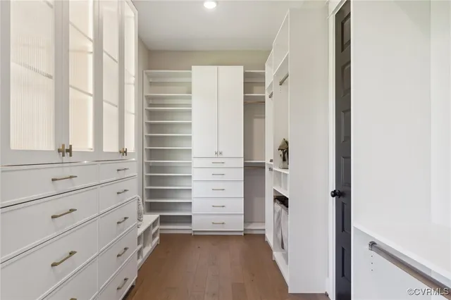 a view of walk in closet with empty racks