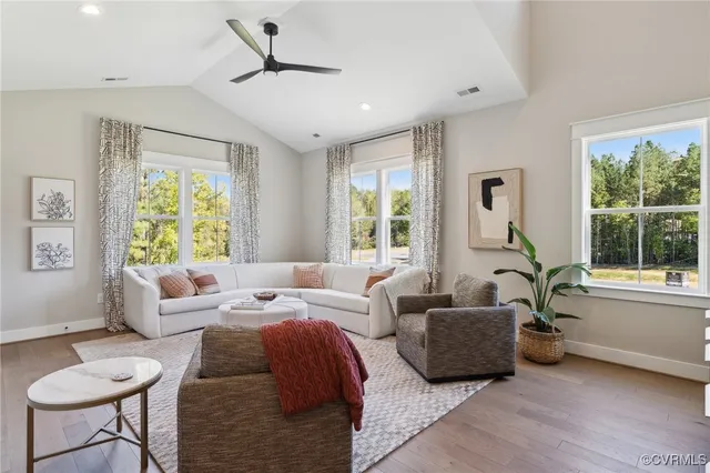 a living room with furniture fireplace and a large window