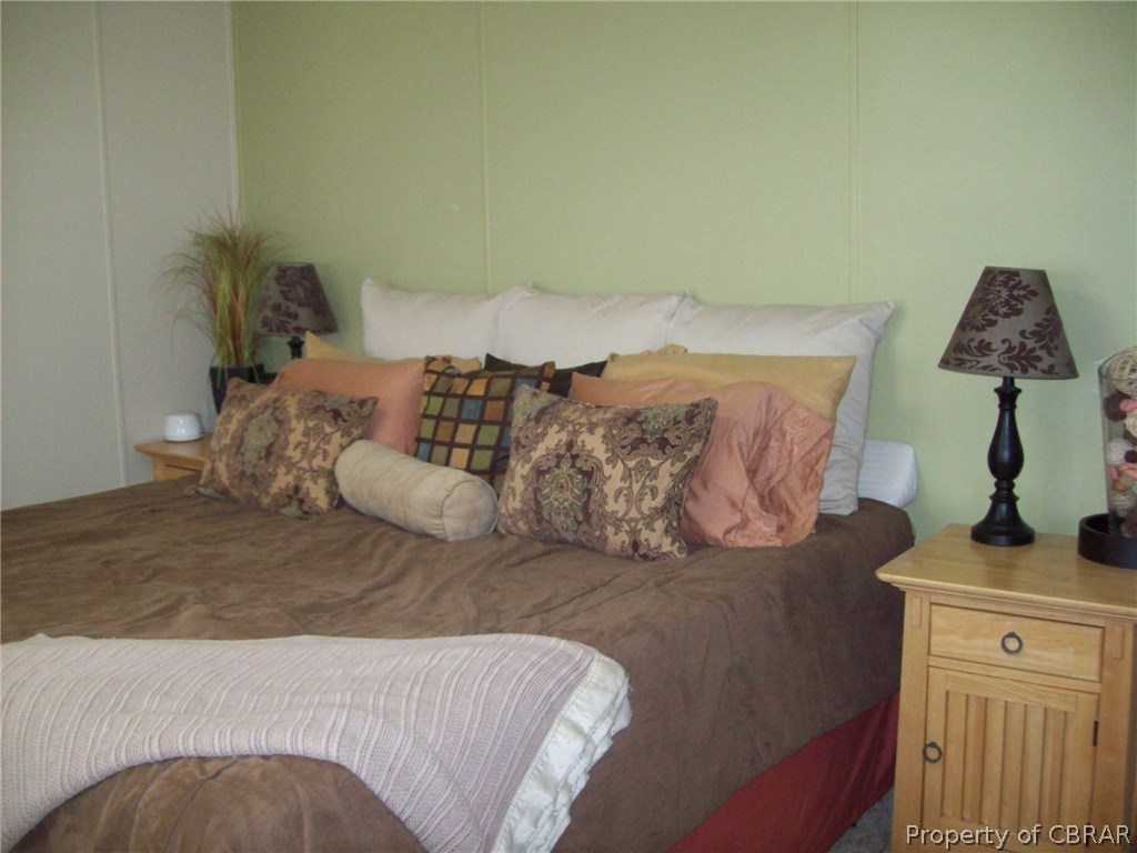 133 Dixon Road Hudgins, VA 23076 - Photo 15 of 25 a bedroom with a bed and a window