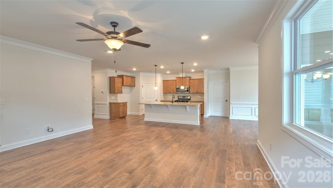 649 River Btm Road Fletcher, NC 28732 - Photo 13 of 40 a view of an empty room and kitchen view with wooden floor and a window