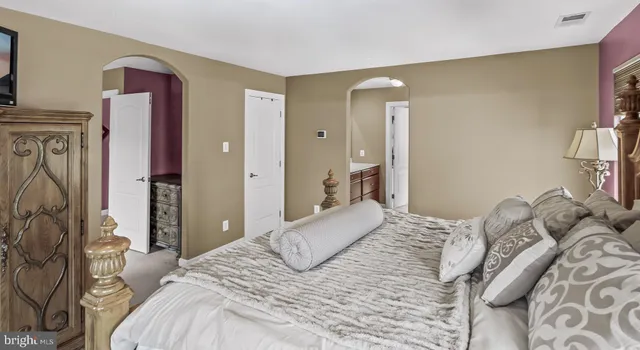 a bedroom with a bed and a mirror