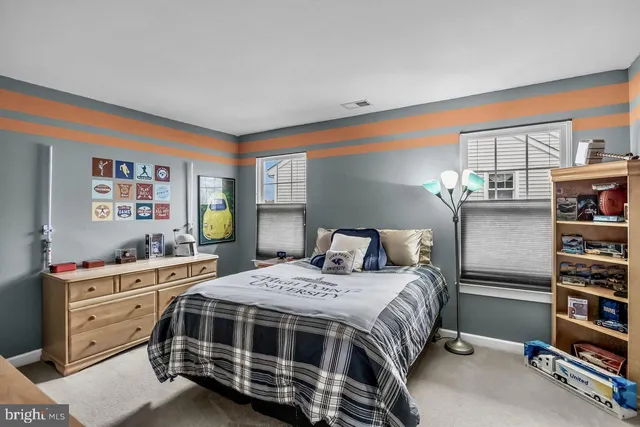 a bedroom with a bed and a dresser in it