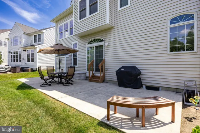 a view of a patio with table and chairs and potted plants