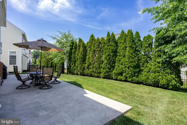 a view of a patio with table and chairs under an umbrella
