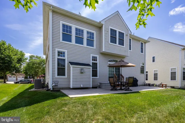 a view of a house with a yard and sitting area