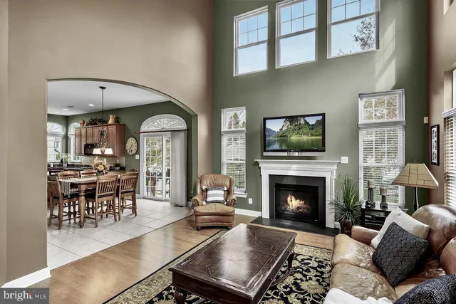 a living room with furniture fireplace and dining table