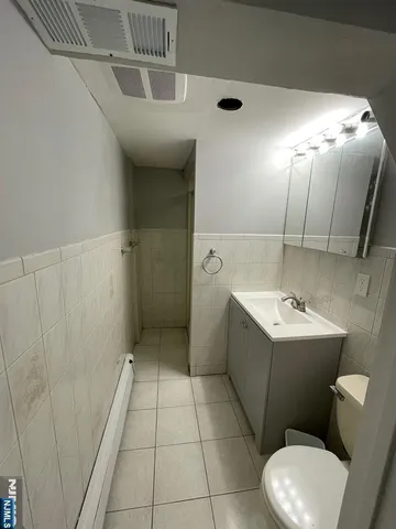 a bathroom with a sink a toilet and bathtub