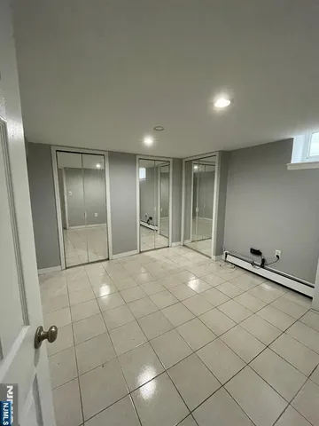 an empty room with a fireplace and wooden floor