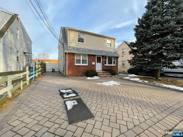 a backyard of a house with barbeque oven and outdoor seating