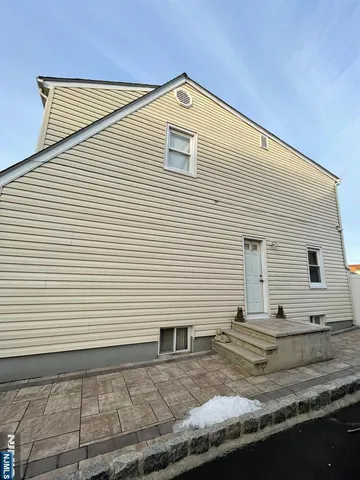 a front view of a house with white walls