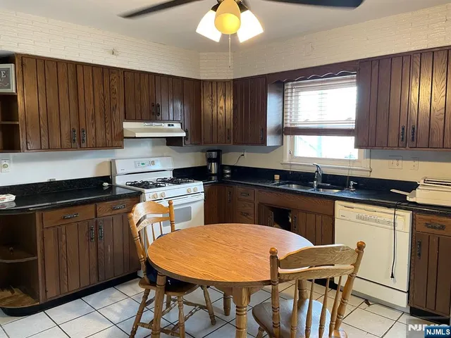 a kitchen with a stove a sink and a refrigerator