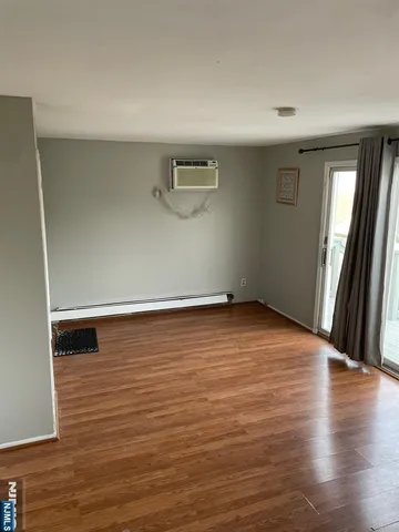 a view of a room with wooden floor