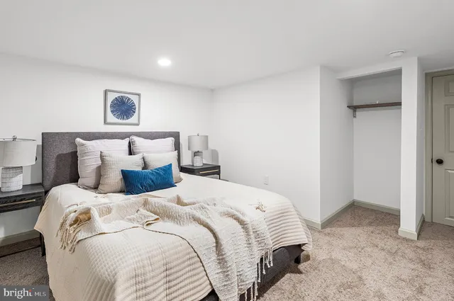 a bedroom with a bed and a painting on the wall