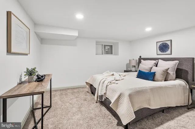 a bedroom with a bed and a potted plant