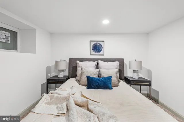 a bed room with a bed and a chair