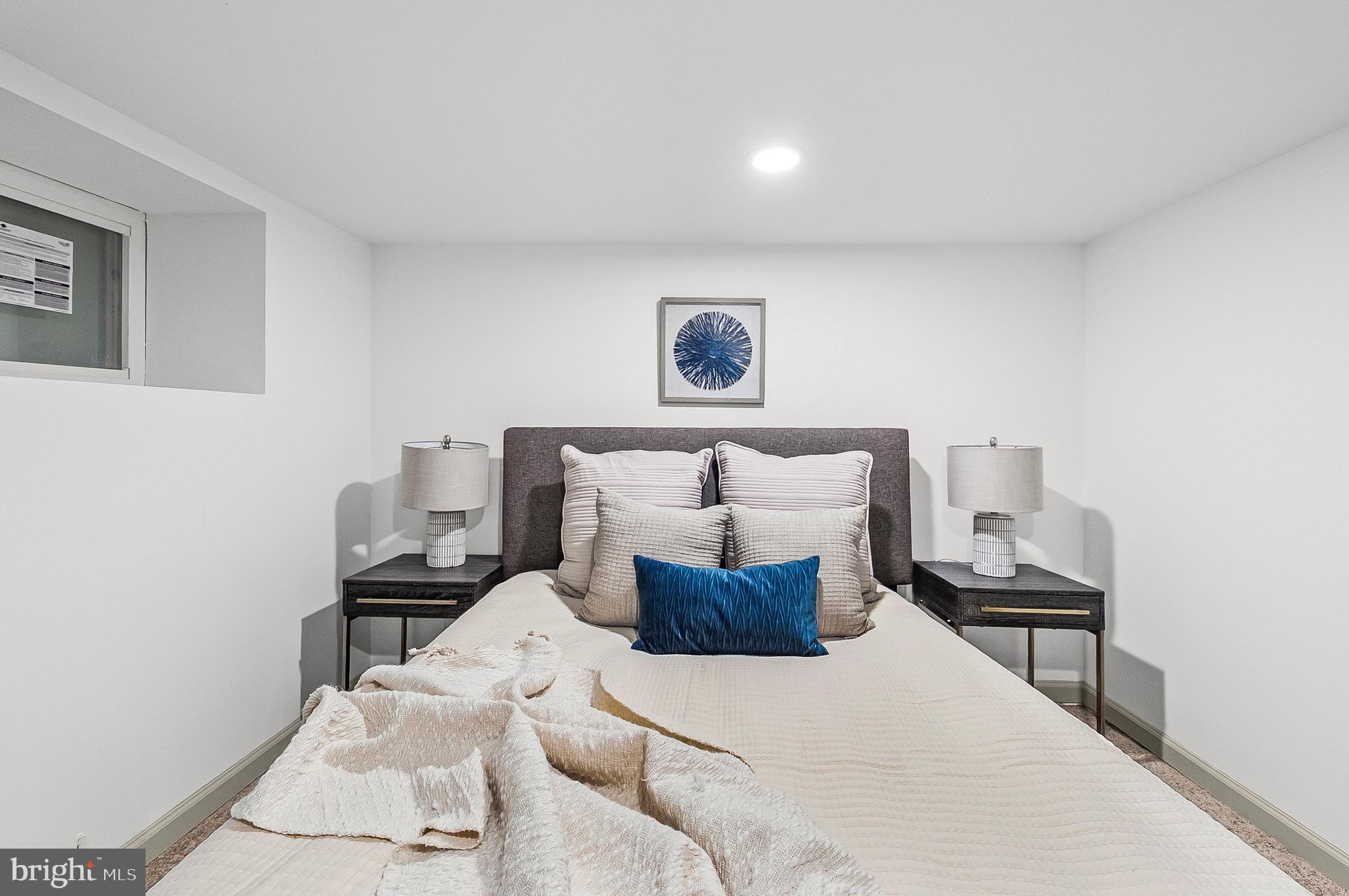 2508 East Preston Street Baltimore, MD 21213 - Photo 14 of 29 a bed room with a bed and a chair