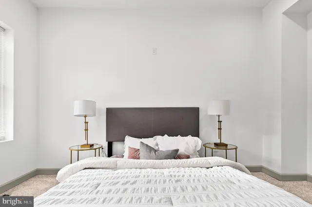 a bedroom with a bed and a night lamp