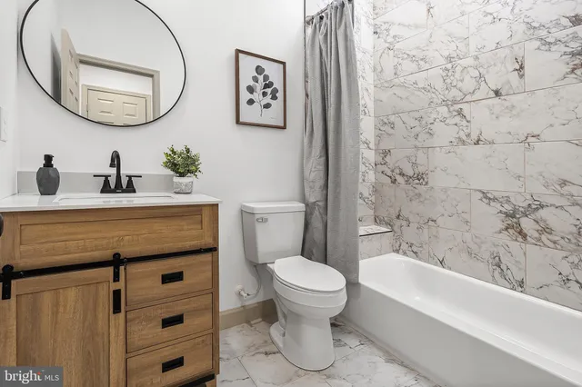a bathroom with a toilet a sink and a mirror